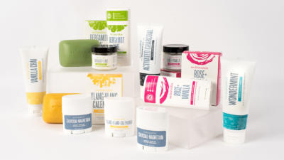 An assortment of Schmidt's deodorant, soap, and toothpaste on white background